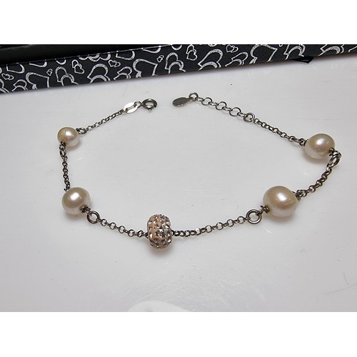 341 - A 925 silver bracelet inset with real pearls and a jewelled charm, total length of 8.5