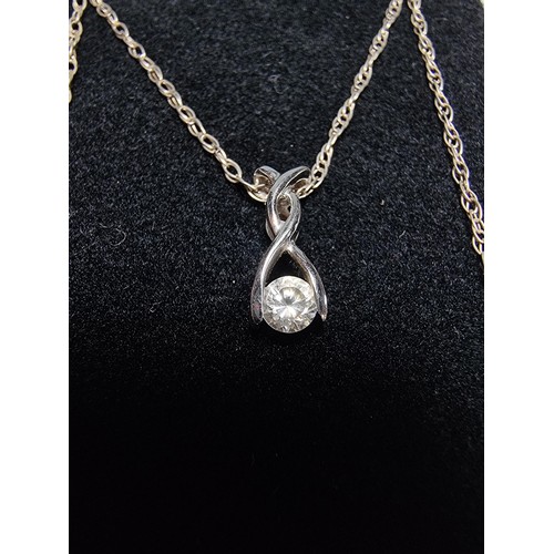 343 - A 9ct white gold pendant inset with a sparkly CZ crystal stone, set on an 18