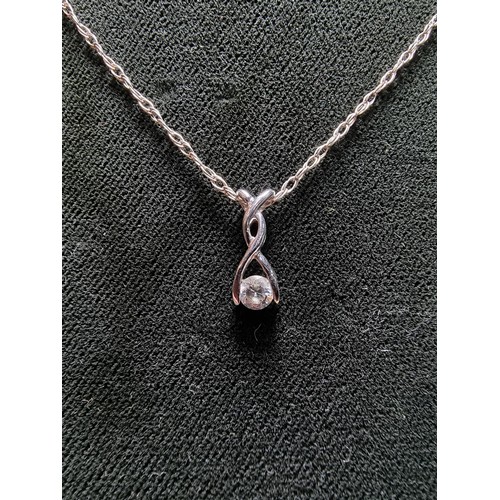 343 - A 9ct white gold pendant inset with a sparkly CZ crystal stone, set on an 18