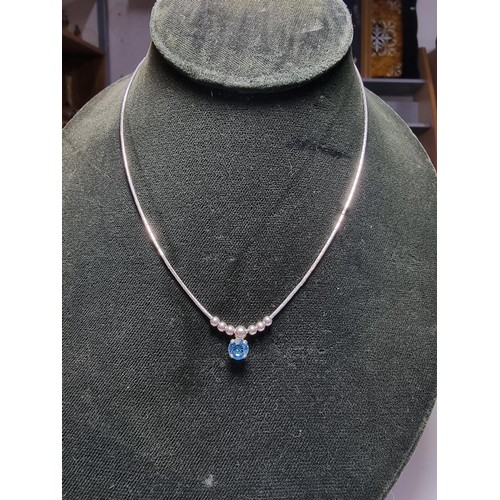 346 - A 925 silver necklace inset with a blue crystal CZ stone. in clean condition, boxed.