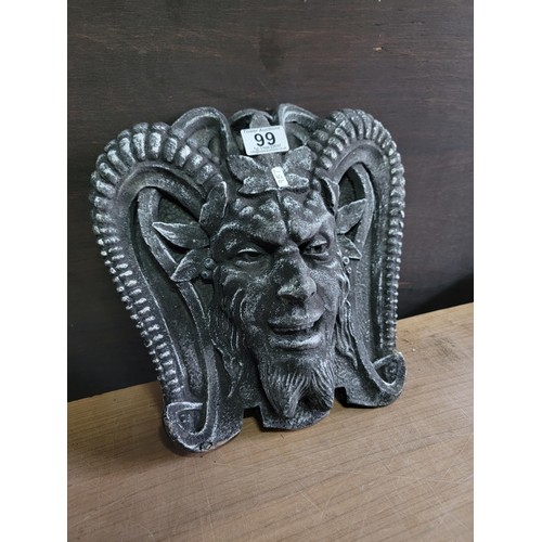 99 - A wall hanging Devil stone ornament in good unused order measures 30cm high, 25cm wide