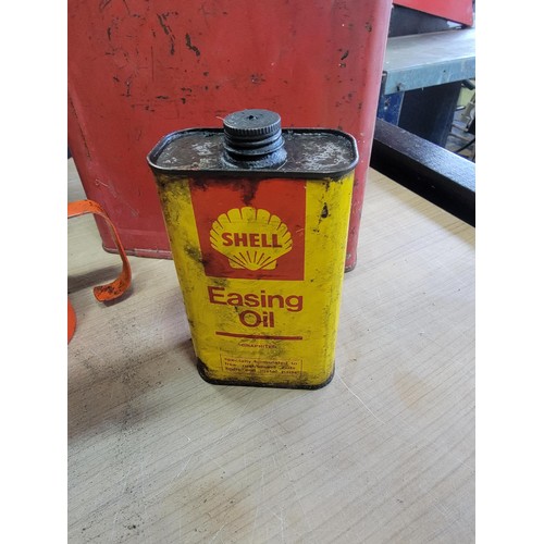 105 - Vintage red metal petrol can along with a Easing oil Shell can and a quantity of 4x vintage oil cans... 