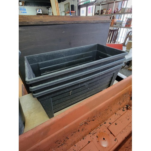 109 - Large quantity of plastic planters inc 2x large handled planters, trough planters along with 2x conc... 