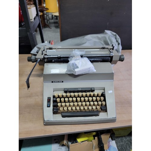 119 - A long carriage Adler Universal 200 typewriter with new ribbon, comes with cover in good overall con... 