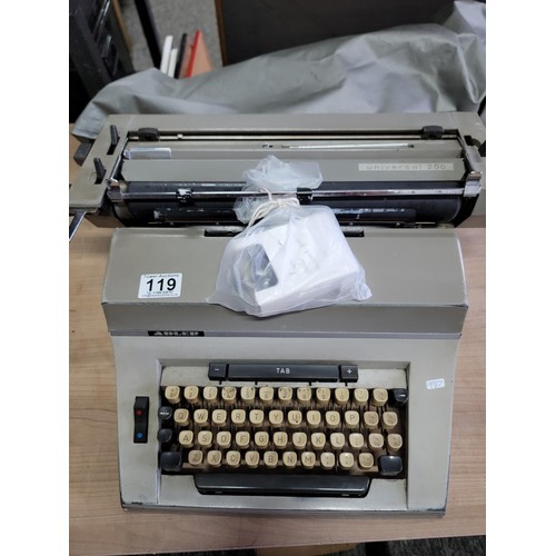 119 - A long carriage Adler Universal 200 typewriter with new ribbon, comes with cover in good overall con... 