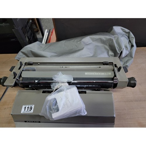 119 - A long carriage Adler Universal 200 typewriter with new ribbon, comes with cover in good overall con... 