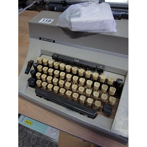 119 - A long carriage Adler Universal 200 typewriter with new ribbon, comes with cover in good overall con... 