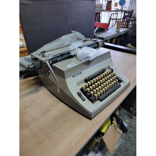 119 - A long carriage Adler Universal 200 typewriter with new ribbon, comes with cover in good overall con... 