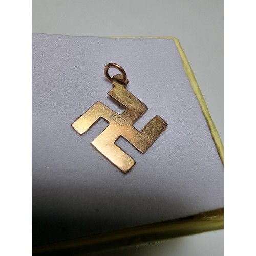 394 - A 9ct yellow gold Swastika pendant/charm, believed to have been found after a Nazi march. Weight of ... 