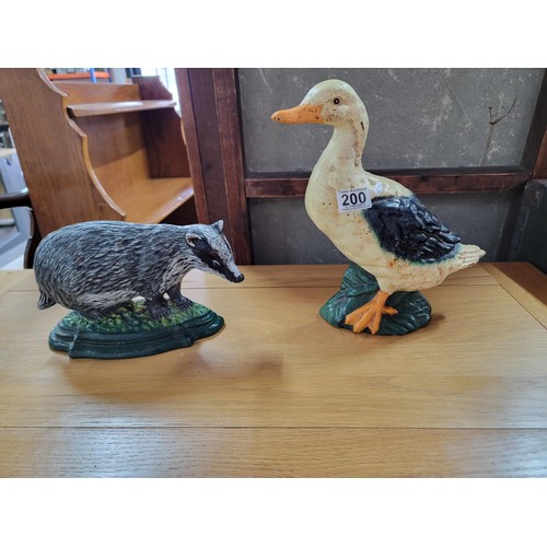 200 - 2x cast iron door stops inc a duck and badger, in good condition well painted height of largest is 3... 