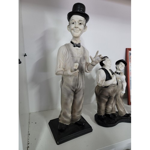 201 - A quantity of Laurel and Hardy figures, some made by Global 4 in total along with a reproduction emp... 