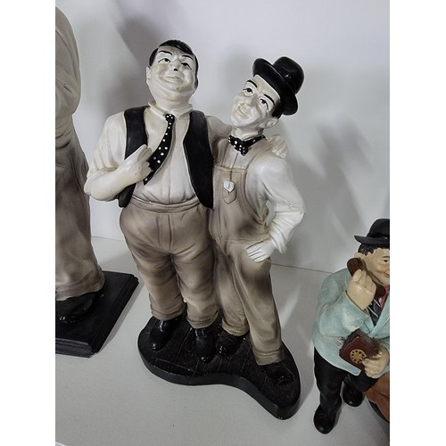 201 - A quantity of Laurel and Hardy figures, some made by Global 4 in total along with a reproduction emp... 