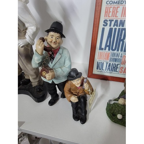 201 - A quantity of Laurel and Hardy figures, some made by Global 4 in total along with a reproduction emp... 