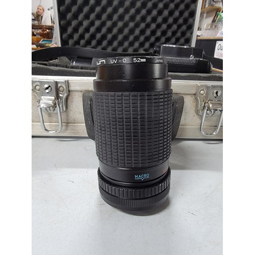 20 - Aluminium padded case containing a Zenith 11 SLR camera a Saitex lens and a Tamron lens all in good ... 