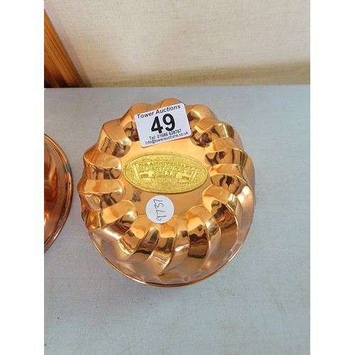 49 - 2x copper Rowntrees jelly moulds one with a plaque largest mesures 9.5cm high by 17cm diameter