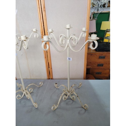 50 - 2x wrought iron candelabras in good order holding 5 candles each  with scroll feet each measure 65cm... 