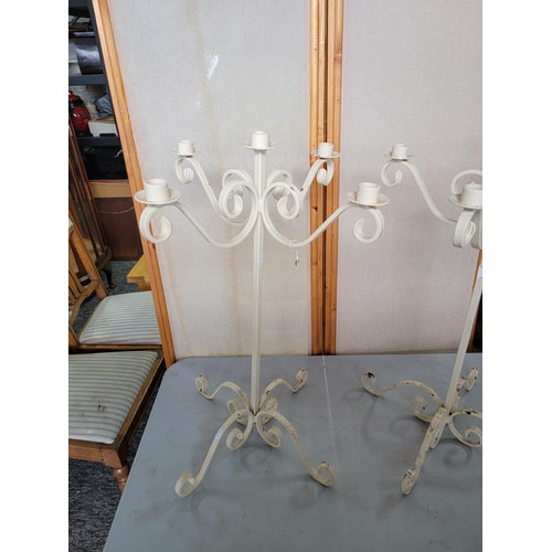 50 - 2x wrought iron candelabras in good order holding 5 candles each  with scroll feet each measure 65cm... 