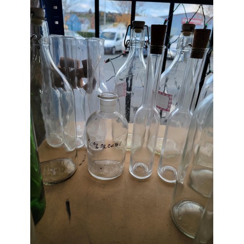 64 - A large selection of 20x glass bottles some including stoppers, inc 6x as new olive oil bottles with... 