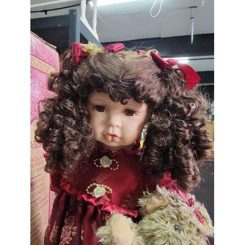 189 - Soft expression hand painted porcelain doll in red dress holding a teddy bear from the series of Dan... 