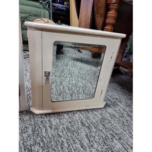 503 - A small vintage bathroom corner cabinet with bevel edged mirror along with a larger bathroom cabinet... 