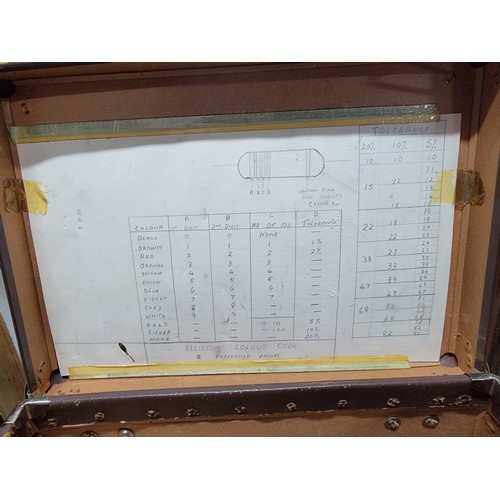 85A - Small brown attache case with capacitor reading chart affixed inside lid along with a small gas lamp