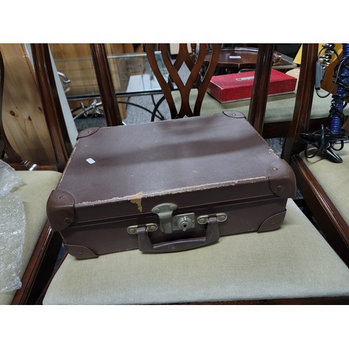 85A - Small brown attache case with capacitor reading chart affixed inside lid along with a small gas lamp