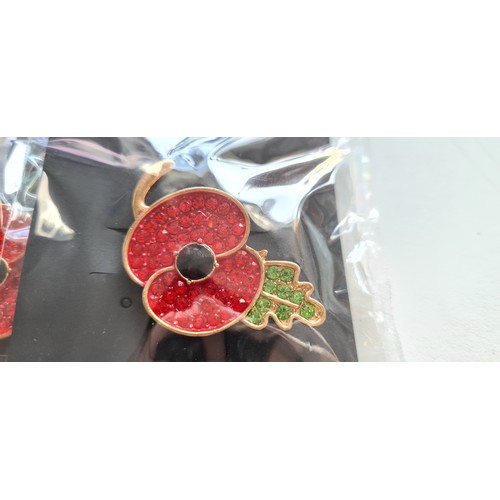 340A - 3x New And sealed gilt metal poppy brooches with a red and green jewelled design, which are sparkly ... 