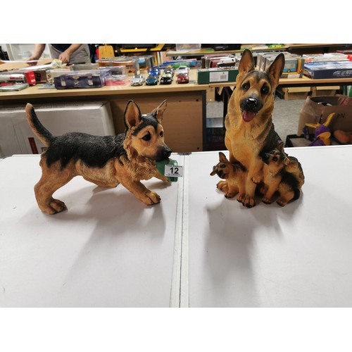 11 - 2x resin Alsatian dogs in good order largest measures height 32cm base diameter 20cm