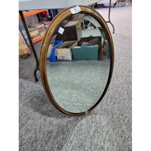 1 - Oval wooden framed bevel edged mirror in good order height 72cm  width 44cm