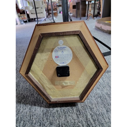 10 - Hexagon shaped framed quartz clock in good order