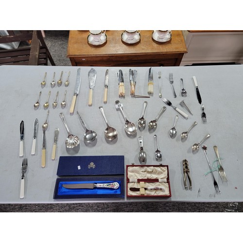 38 - Large quantity of cutlery inc pickle fork, serving spoons, apostle spoons, nut cracker, tea strainer... 