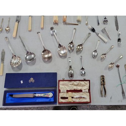 38 - Large quantity of cutlery inc pickle fork, serving spoons, apostle spoons, nut cracker, tea strainer... 