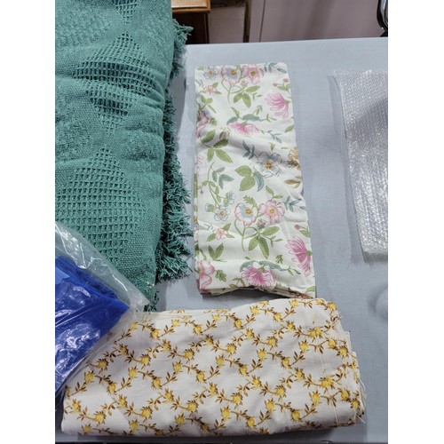 44 - Large quantity of fabric inc floral design, towels, along with Christmas table clothes, net curtains... 