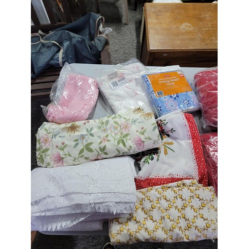 44 - Large quantity of fabric inc floral design, towels, along with Christmas table clothes, net curtains... 