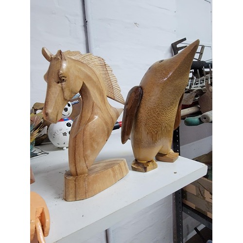 79 - Large quantity of fair trade wooden figures inc foxes, horses head, penguin, giraffe heads, cormoran... 