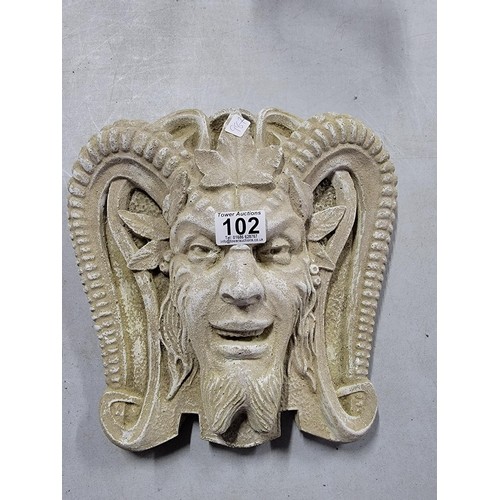 102 - Concrete cream wall plaque of a devil in good order 30cm high 28cm width