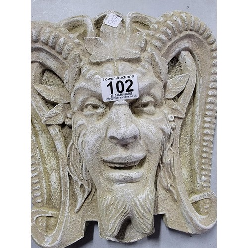 102 - Concrete cream wall plaque of a devil in good order 30cm high 28cm width