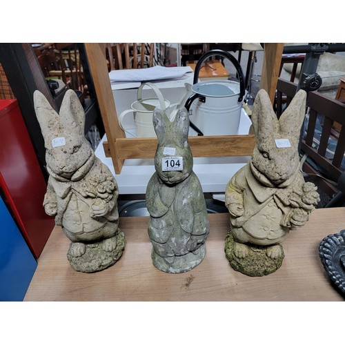 104 - Quantity of 3x stone ware and concrete rabbits, one has damage to one ear, height of tallest 45cm ba... 