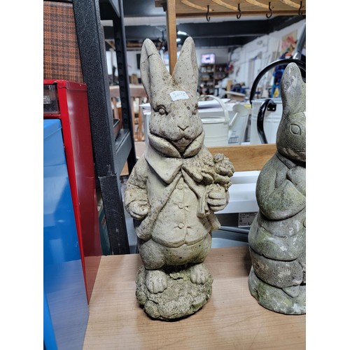 104 - Quantity of 3x stone ware and concrete rabbits, one has damage to one ear, height of tallest 45cm ba... 