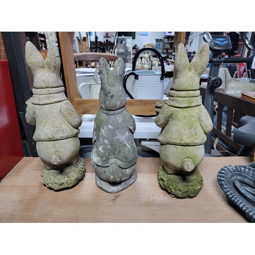 104 - Quantity of 3x stone ware and concrete rabbits, one has damage to one ear, height of tallest 45cm ba... 