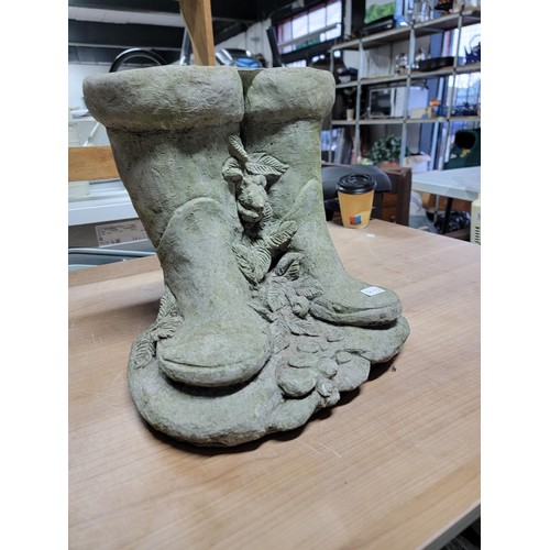 105 - Pair of concrete boot planters with a vine design between them in good order height 31cm base diamet... 