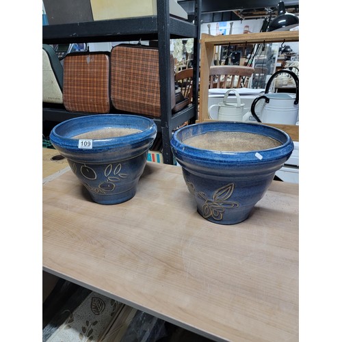 109 - 2x large impressive blue glazed planters with a floral design stoneware in good order 
height 28cm d... 