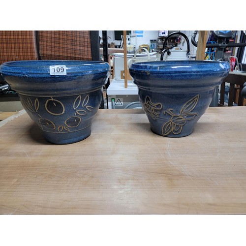 109 - 2x large impressive blue glazed planters with a floral design stoneware in good order 
height 28cm d... 