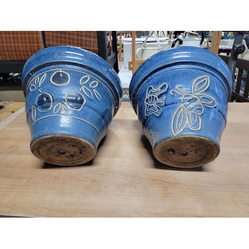 109 - 2x large impressive blue glazed planters with a floral design stoneware in good order 
height 28cm d... 