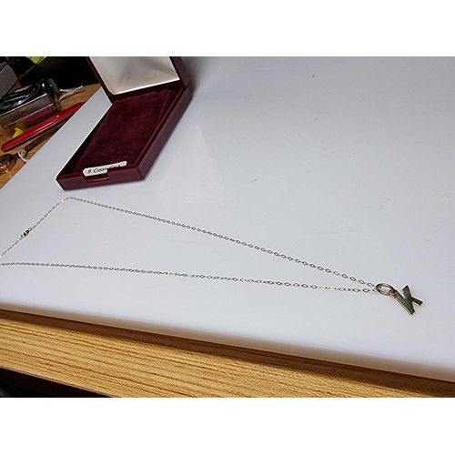 495 - Hallmarked yellow gold necklace with a letter K pendant in clean condition boxed ready.
18