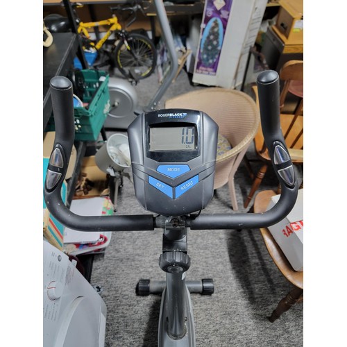 198 - Roger black exercise bike in working order with fully working digital screen has a tension control, ... 