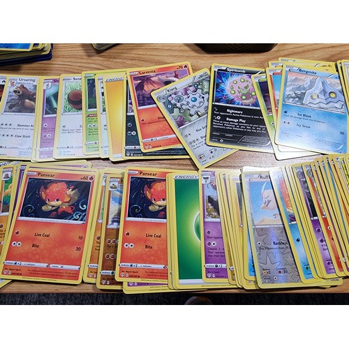 50 - A large quantity of approx 300 Pokémon cards fitted in a metal Pokémon tin along with 4 other empty ... 