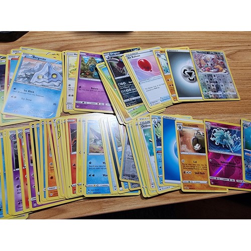 50 - A large quantity of approx 300 Pokémon cards fitted in a metal Pokémon tin along with 4 other empty ... 