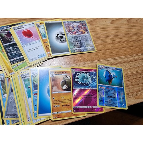 50 - A large quantity of approx 300 Pokémon cards fitted in a metal Pokémon tin along with 4 other empty ... 