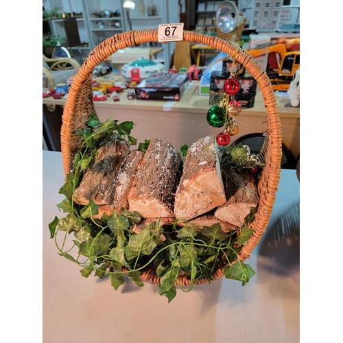 67 - 2x wicker log baskets full of real logs, with bauble and ivy decorations both in good order